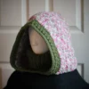 Handmade oversized knit balaclava hood in jasmine wheat stitch with dusty rose turtleneck, modeled on mannequin