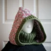 Oversized jasmine wheat knit balaclava with dusty rose turtleneck, side view showing texture detail