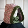 Handmade wheat stitch knit balaclava hood with dusty rose turtleneck, front view on mannequin