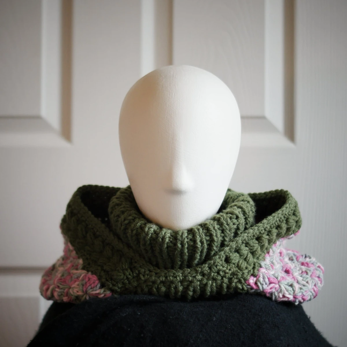 Oversized wheat stitch knit balaclava with dusty rose turtleneck, back view on mannequin showing hood drape