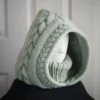 Sage green knit balaclava worn by mannequin, side view