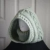 Sage green knit balaclava worn by mannequin, side view