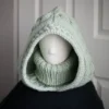 Sage green knit balaclava worn by mannequin, front view