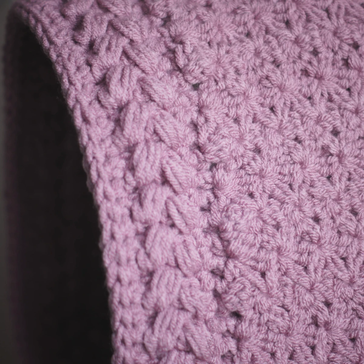 Close-up of jasmine wheat knit stitch on mauve balaclava