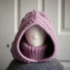 Chunky knit balaclava in mauve with cable details and wheat stitch edging, front view with turtleneck