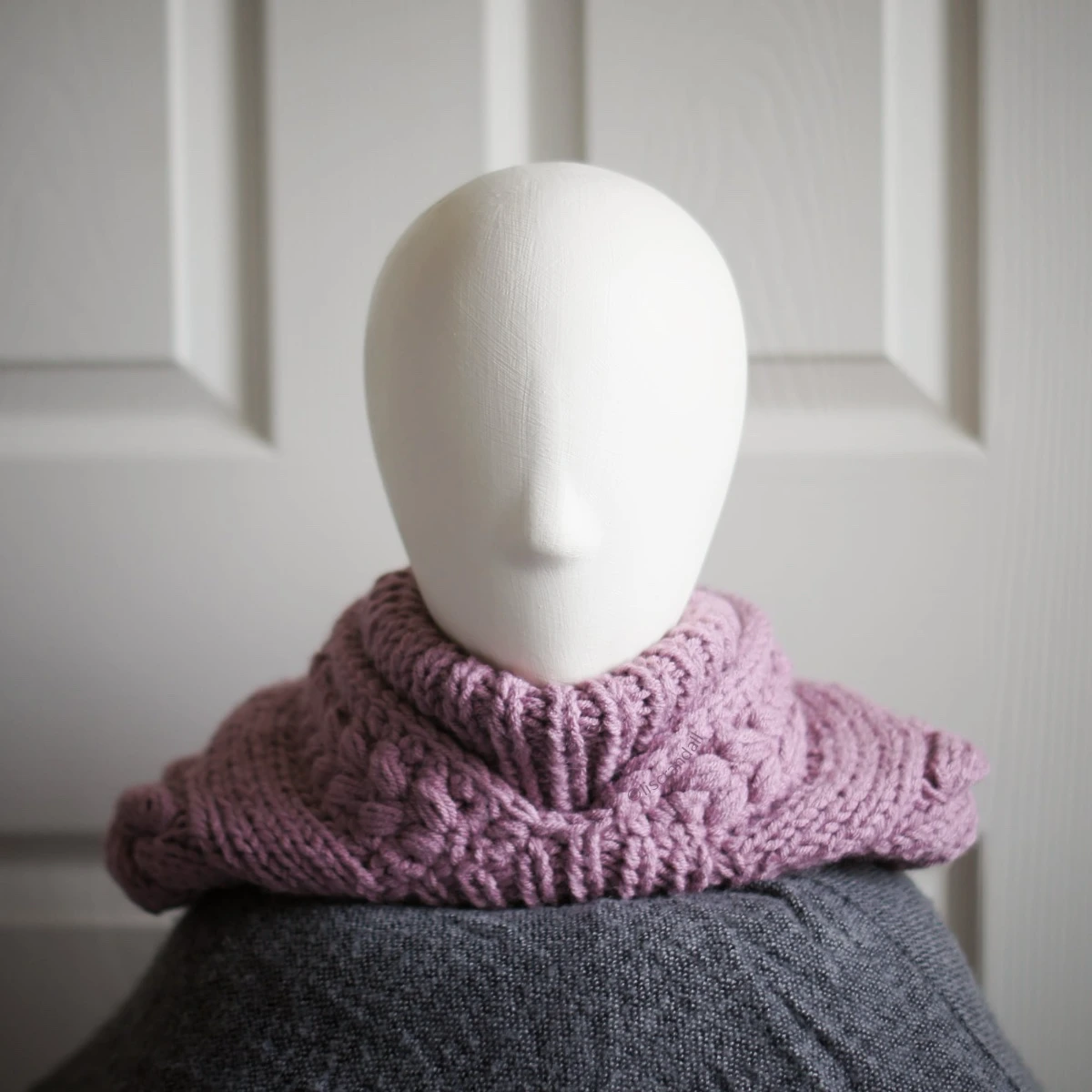 Chunky knit balaclava in mauve with cable details and wheat stitch edging, front view hood dropped back