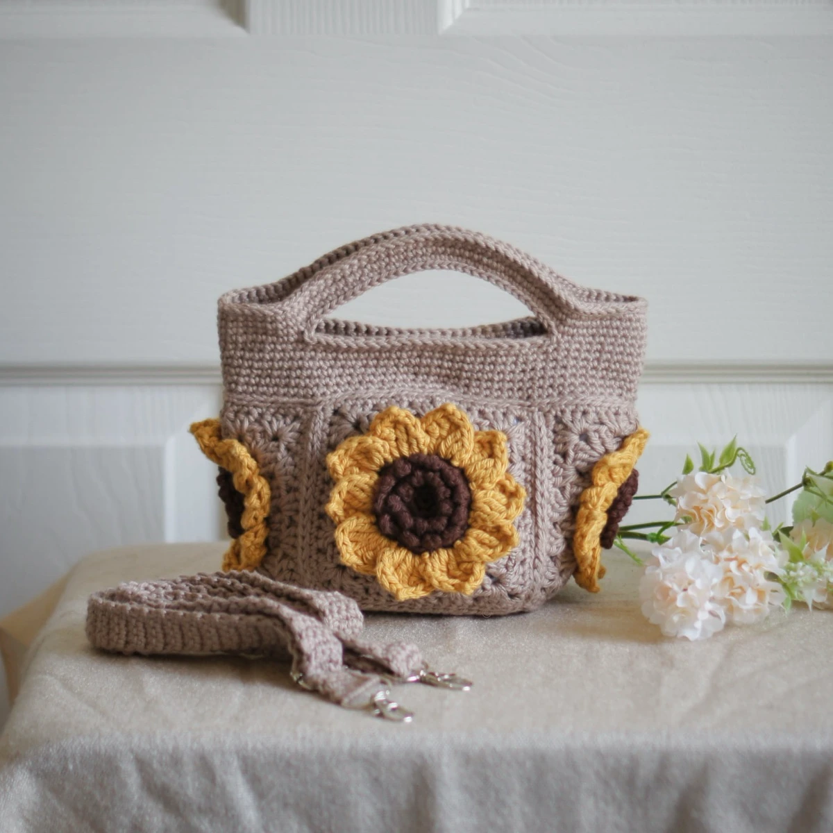 crochet mini bag in khaki color formed with 3D sunflower granny squares. Comes with adjustable strap.