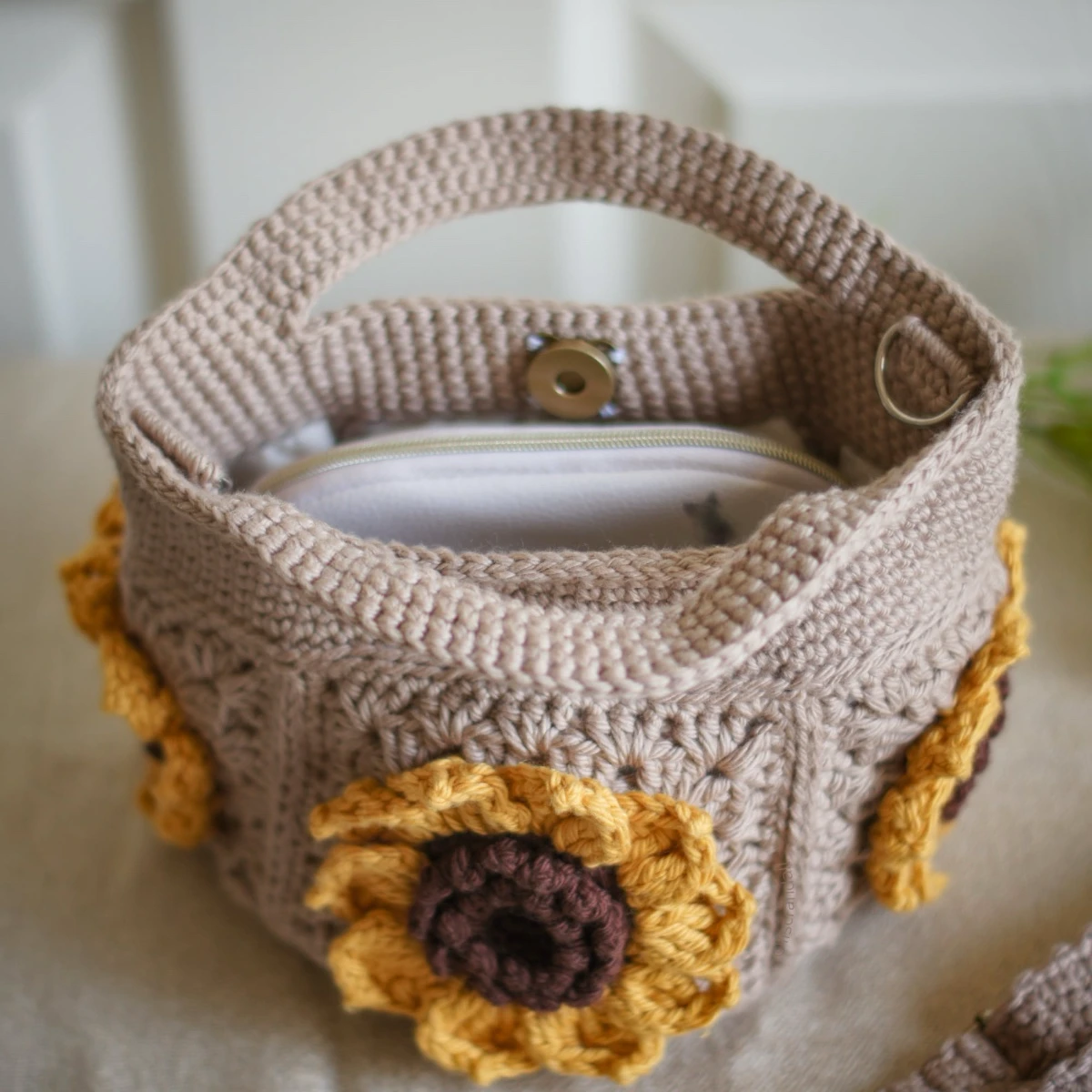 Inside view of crochet mini bag in khaki color formed with 3D sunflower granny squares. Comes with adjustable strap.