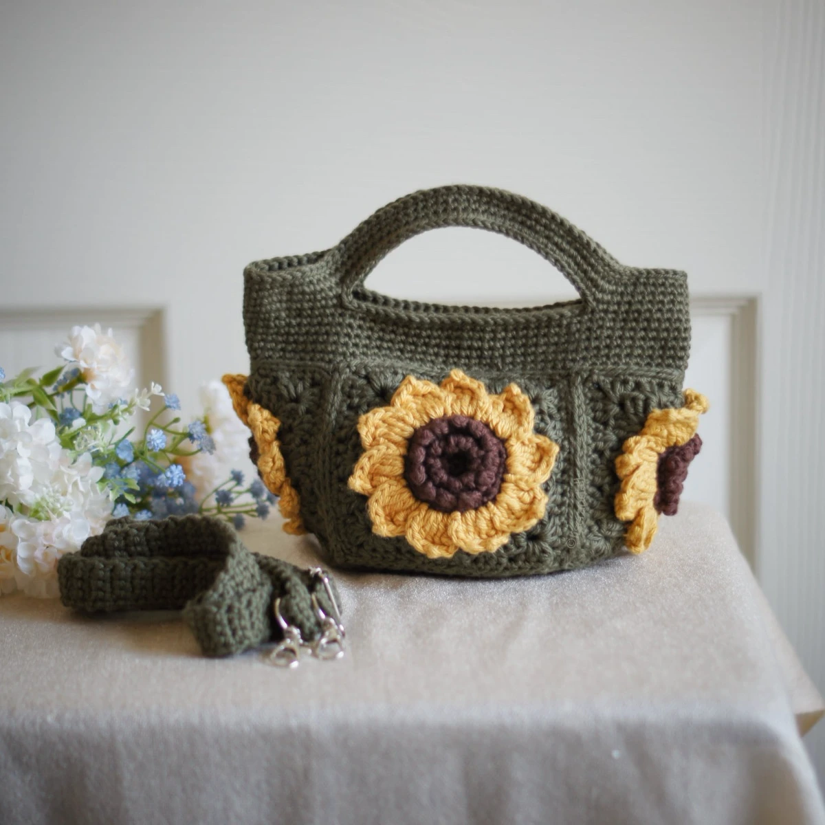 crochet mini bag in olive green color formed with 3D sunflower granny squares. Comes with adjustable strap.