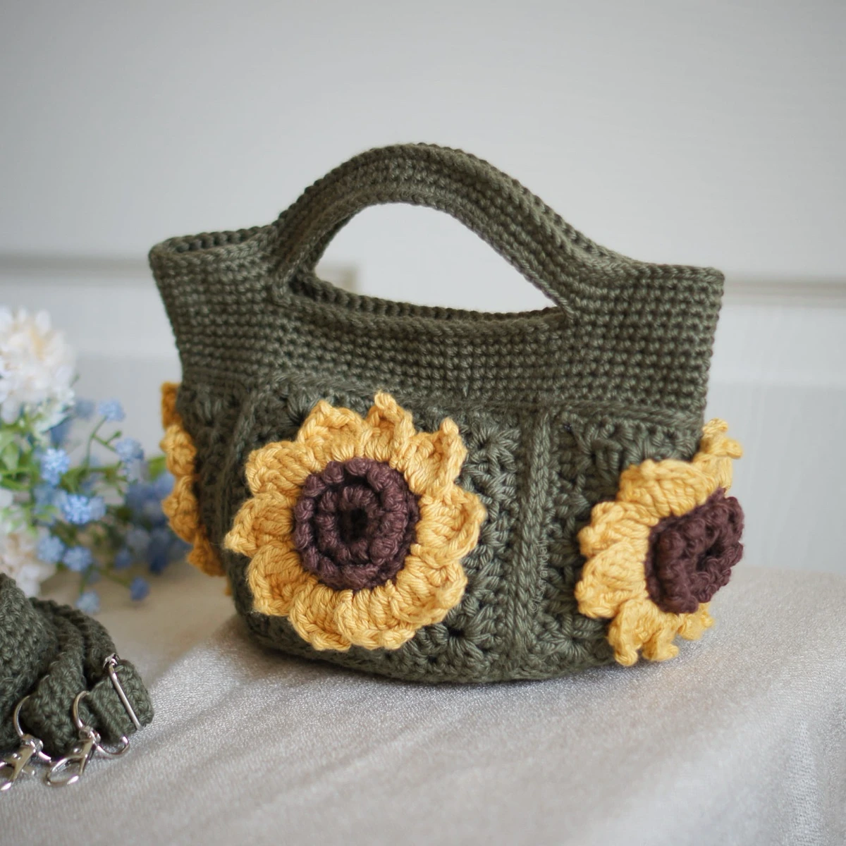 crochet mini bag in olive green color formed with 3D sunflower granny squares. Comes with adjustable strap.