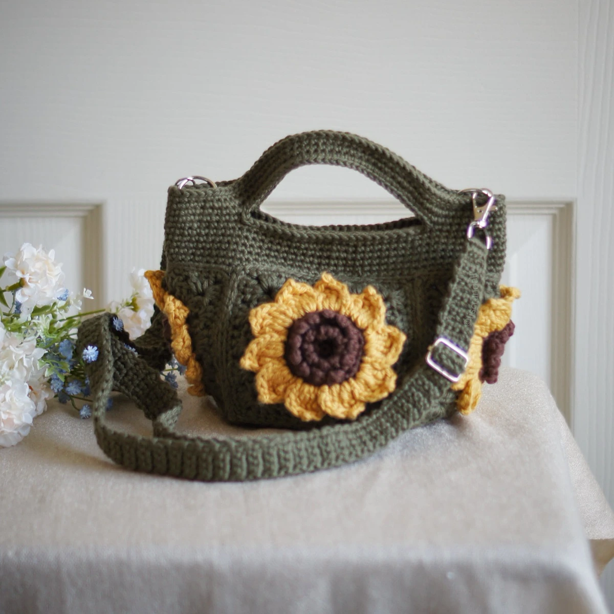 crochet mini bag in olive green color formed with 3D sunflower granny squares. Comes with adjustable strap.
