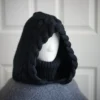 Black merino knit balaclava hood with twist edging and folded turtleneck worn by mannequin, side view