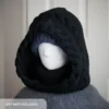 Black merino knit balaclava hood with twist edging and folded turtleneck worn by mannequin, style with a beanie under the hood