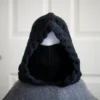 Black merino knit balaclava hood with twist edging and folded turtleneck worn by mannequin, styled with turtleneck rolled up to cover face
