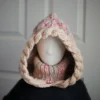 Oatmeal sprinkles knit balaclava hood with twist edging and folded turtleneck worn by mannequin