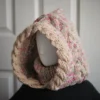 Oatmeal sprinkles knit balaclava hood with twist edging and folded turtleneck worn by mannequin, side view