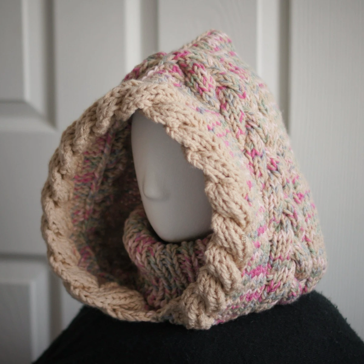 Oatmeal sprinkles knit balaclava hood with twist edging and folded turtleneck worn by mannequin, side view