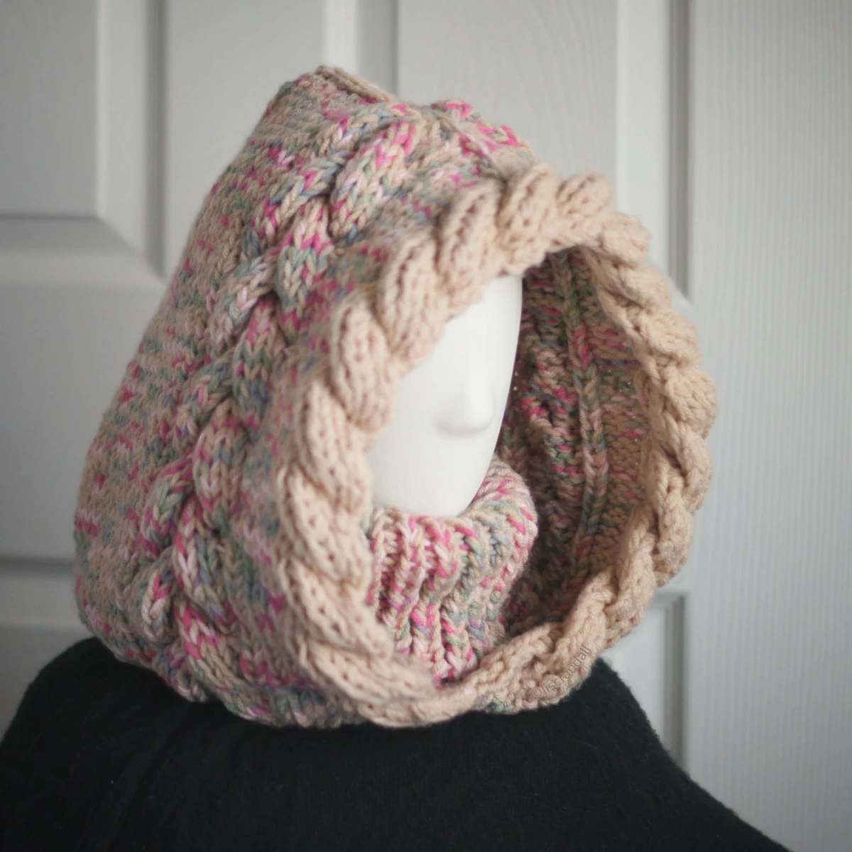 Oatmeal sprinkles knit balaclava hood with twist edging and folded turtleneck worn by mannequin, side view