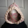 Oatmeal sprinkles knit balaclava hood with twist edging and turtleneck rolled up to cover face, worn by mannequin