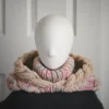 Oatmeal sprinkles knit balaclava hood with twist edging and turtleneck, with the hood dropped down on mannequin's head