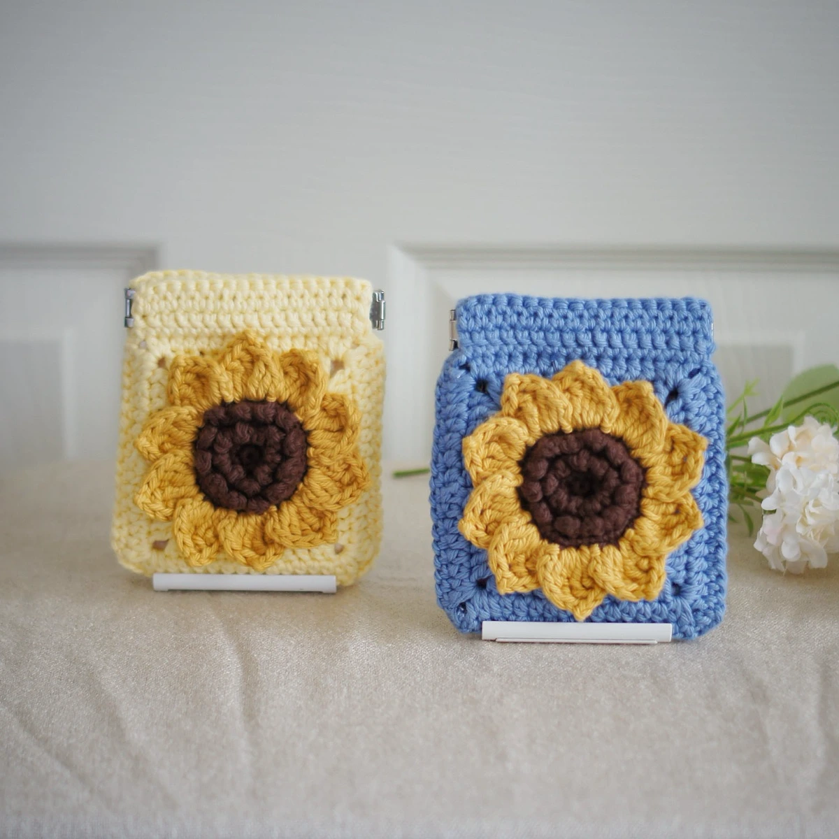 crochet sunflower squeeze pouch in yellow and blue